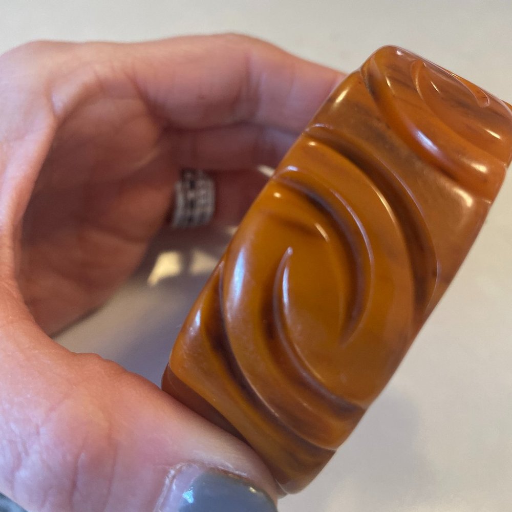 Bakelite bangle intricate carvings shades or orange and brown marbling